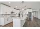 Well-lit kitchen featuring an island with white cabinets, stainless steel appliances, and modern pendant lighting at 1780 Draughton Dr, Zephyrhills, FL 33541