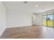 Bright living room with tile flooring and access to a patio, offering views of the backyard at 1780 Draughton Dr, Zephyrhills, FL 33541