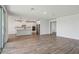 Spacious living room that flows seamlessly into the kitchen, with tile floors and natural light at 1780 Draughton Dr, Zephyrhills, FL 33541