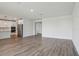 Open-concept living space with tile floors seamlessly flowing into the kitchen at 1780 Draughton Dr, Zephyrhills, FL 33541