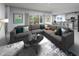Open-concept living room with a comfortable sectional, stylish decor, and a seamless flow to the kitchen and dining area at 1780 Draughton Dr, Zephyrhills, FL 33541