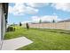 Expansive backyard with lush green lawn, privacy fence and serene landscaping, ready for outdoor enjoyment at 1828 Brekey Way, Zephyrhills, FL 33541