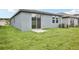 Spacious backyard with green lawn and patio area at 1828 Brekey Way, Zephyrhills, FL 33541