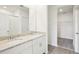 Bathroom with double sinks, granite countertops, walk-in closet, and tile flooring at 1828 Brekey Way, Zephyrhills, FL 33541