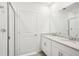 Bathroom featuring double vanity with granite countertops and tiled glass door shower at 1828 Brekey Way, Zephyrhills, FL 33541