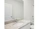 Clean bathroom featuring granite countertop, white cabinet, and tile shower and tub at 1828 Brekey Way, Zephyrhills, FL 33541