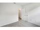 Empty bedroom featuring carpeted flooring, white walls, and closet with sliding doors at 1828 Brekey Way, Zephyrhills, FL 33541