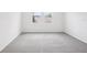 Bright, empty bedroom with two windows, plush carpet, and neutral decor at 1828 Brekey Way, Zephyrhills, FL 33541