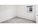 Clean and empty bedroom with carpet and a window, offering a neutral design at 1828 Brekey Way, Zephyrhills, FL 33541