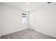 Unfurnished bedroom with carpet, a window, and a door, offering a blank canvas at 1828 Brekey Way, Zephyrhills, FL 33541