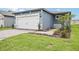 Charming home exterior with well-kept lawn, brick driveway, and modern garage door at 1828 Brekey Way, Zephyrhills, FL 33541