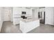 Modern kitchen with stainless steel appliances, granite countertops, and a large kitchen island at 1828 Brekey Way, Zephyrhills, FL 33541