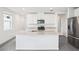 Modern kitchen with white cabinets, stainless steel appliances, and granite countertops at 1828 Brekey Way, Zephyrhills, FL 33541