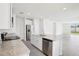 Bright open-plan kitchen with stainless steel appliances and a central island that overlooks the backyard at 1828 Brekey Way, Zephyrhills, FL 33541