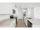 Modern kitchen with granite counters, stainless appliances, and bright white cabinetry at 1828 Brekey Way, Zephyrhills, FL 33541