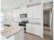 Modern kitchen with stainless steel appliances, granite countertops, and white cabinetry at 1828 Brekey Way, Zephyrhills, FL 33541