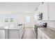 Bright kitchen with granite countertops, stainless steel appliances, and ample cabinet space at 1828 Brekey Way, Zephyrhills, FL 33541