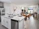 Open-concept kitchen with a stainless dishwasher that overlooks the dining and living areas at 1828 Brekey Way, Zephyrhills, FL 33541