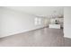 Open-concept living room featuring tile floors, bright windows, and a modern kitchen at 1828 Brekey Way, Zephyrhills, FL 33541