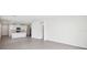 Open concept living space featuring tile floors and a view into the modern kitchen at 1828 Brekey Way, Zephyrhills, FL 33541