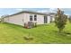 The backyard features a well manicured lawn, a privacy fence and an air conditioning unit at 1847 Brekey Way, Zephyrhills, FL 33541