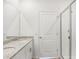Modern bathroom with double sinks, granite countertops, and a glass-enclosed shower at 1847 Brekey Way, Zephyrhills, FL 33541