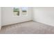 Neutral bedroom with carpet and natural light streaming in from windows at 1847 Brekey Way, Zephyrhills, FL 33541