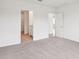 Neutral bedroom with carpet, a walk-in closet, and ensuite bathroom entrance at 1847 Brekey Way, Zephyrhills, FL 33541