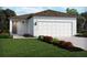 Charming single-Gathering home featuring a two-car garage, neutral paint and a beautifully landscaped front yard at 1847 Brekey Way, Zephyrhills, FL 33541