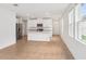 Well-lit kitchen features an island with white cabinets and modern appliances, perfect for cooking and entertaining at 1847 Brekey Way, Zephyrhills, FL 33541