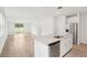 Open-concept kitchen with granite counters, stainless appliances, and seamless flow to the living area at 1847 Brekey Way, Zephyrhills, FL 33541