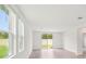 Bright living space with large windows and neutral walls create a serene and welcoming atmosphere at 1847 Brekey Way, Zephyrhills, FL 33541