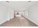 Spacious open-concept living area with tile flooring, connecting to the kitchen with stainless steel appliances at 1847 Brekey Way, Zephyrhills, FL 33541