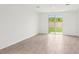 Bright living room features tile flooring and sliding glass doors to the backyard at 1847 Brekey Way, Zephyrhills, FL 33541