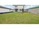 A spacious backyard features a well-maintained lawn perfect for outdoor activities at 1855 Brekey Way, Zephyrhills, FL 33541