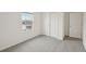 Bedroom featuring neutral carpet, white walls, a window, and a closet at 1855 Brekey Way, Zephyrhills, FL 33541