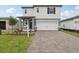Charming two-story home with a two-car garage and a beautifully paved driveway at 1855 Brekey Way, Zephyrhills, FL 33541