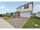New construction home with a two-car garage, paved driveway and manicured lawn at 1855 Brekey Way, Zephyrhills, FL 33541