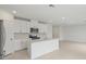 Open-concept kitchen with white cabinetry, stainless steel appliances, and a center island at 1855 Brekey Way, Zephyrhills, FL 33541