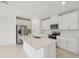 Modern kitchen featuring white cabinets, stainless steel appliances, and a large island at 1855 Brekey Way, Zephyrhills, FL 33541