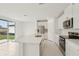Bright kitchen with an island, stainless steel appliances, and sliding glass doors at 1855 Brekey Way, Zephyrhills, FL 33541
