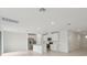 Bright kitchen features white cabinets, stainless steel appliances, and an island with seating at 1855 Brekey Way, Zephyrhills, FL 33541