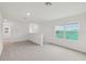 Upstairs living area with plush carpeting, neutral walls, and natural light at 1855 Brekey Way, Zephyrhills, FL 33541