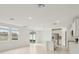 Open concept living room and kitchen with an island, stainless steel appliances and tile floors at 1855 Brekey Way, Zephyrhills, FL 33541