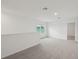 Upstairs loft with gray carpet, white walls and trim, and natural light at 1855 Brekey Way, Zephyrhills, FL 33541