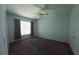 Spacious carpeted bedroom featuring a ceiling fan and natural light from the window at 5000 Culbreath Key Way # 9-101, Tampa, FL 33611