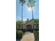 Clubhouse entrance framed by swaying palms and lush tropical landscaping at 5000 Culbreath Key Way # 9-101, Tampa, FL 33611