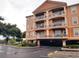 A three-story condo building featuring stucco walls, balconies, and covered parking at 5000 Culbreath Key Way # 9-101, Tampa, FL 33611