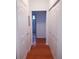 Hallway with closet doors and wood floors offers great storage space and leads to the bathroom at 5000 Culbreath Key Way # 9-101, Tampa, FL 33611