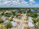 Aerial view of a home surrounded by lush greenery in a tranquil neighborhood setting at 5415 Riddle Rd, Holiday, FL 34690